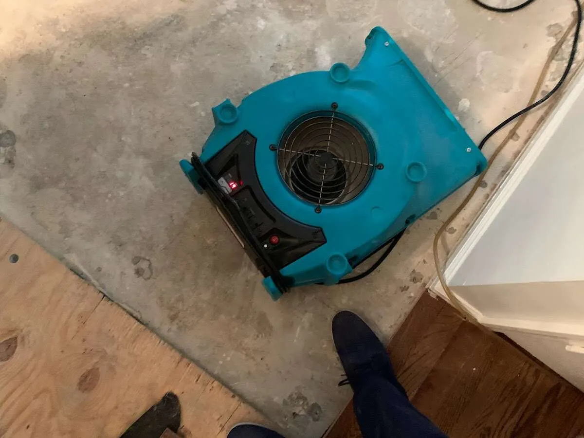 Air mover drying subfloor during Commercial Water Damage Restoration in Cutler Bay